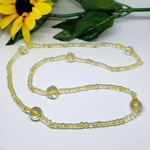 Clear beaded necklace on yellow strand 28"